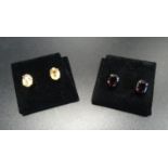 TWO PAIRS OF OVAL CUT GEM SET STUD EARRINGS one pair possibly peach/yellow sapphires, the other