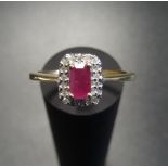 RUBY AND DIAMOND CLUSTER RING the central ruby in diamond surround, on nine carat gold shank, ring
