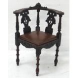 19th CENTURY CARVED OAK CORNER CHAIR the shaped backrail with central raised carved cherub head