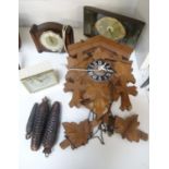 BLACK FOREST CUCKOO CLOCK with carved oak leaf decoration around the circular dial with Roman