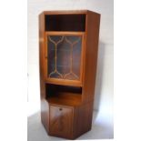 TEAK CORNER CABINET with upper open compartment above a glazed door with a glazed shelved