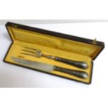 FRENCH CARVING SET comprising a three pronged fork and knife with embossed silver plated handles,
