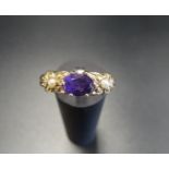 AMETHYST AND SEED PEARL DRESS RING the central oval cut amethyst flanked by seed pearl set moulded