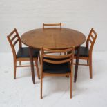 TEAK EXTENDING DINING TABLE with a pull apart top revealing a fold out leaf, standing on shaped