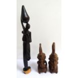 PAIR OF CARVED AFRICAN FERTILITY FIGURES smoking a pipe, and a woman kneeling and having an integral