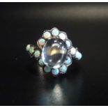 UNUSUAL OPAL AND MOONSTONE DRESS RING the central oval cabochon moonstone in opal surround with