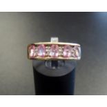 PINK SAPPHIRE AND DIAMOND RING the five oval cut sapphires separated by small diamonds, on nine