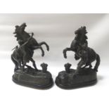PAIR OF SPELTER FIGURES each depicting a groom with a rearing horse on a naturalistic base, raised