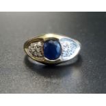 SAPPHIRE AND DIAMOND RING the central oval cut sapphire flanked by multi diamond set shoulders, on