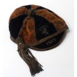 VICTORIAN SPORTING CAP with bullion embroidered lion rampant beneath 'Emmanuel' and dated 1889,