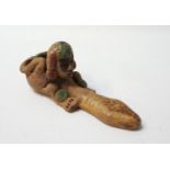 SOUTH AMERICAN EARTHENWARE PHALLIC PIPE depicting a painted man crouching with his arms wrapped
