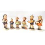 FIVE PORCELAIN GOEBEL FIGURES depicting young children and a similar German figure marked M.J.H (6)