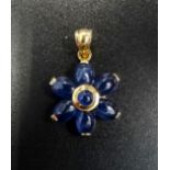 SAPPHIRE SET FLOWER DESIGN PENDANT the central round cabochon sapphire surrounded by six oval