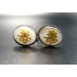 PAIR OF HONG KONG STERLING SILVER CUFFLINKS the oval tops with mother of pearl and applied character