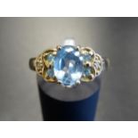 BLUE TOPAZ AND DIAMOND DRESS RING the central oval cut topaz flanked by two blue topaz and one