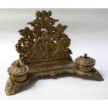 VICTORIAN STYLE BRASS DESKSTAND with scrolled and figural pierced decoration, letter rack, pen