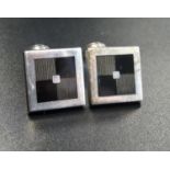 PAIR OF DESIGNER SILVER AND ENAMEL CUFFLINKS with square tops and shaped fasteners, Birmingham 2000