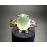 PRASIOLITE AND CLEAR GEM SET DRESS RING the central oval cut prasiolite flanked by clear