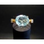 AQUAMARINE AND DIAMOND DRESS RING the central oval cut aquamarine approximately 3cts flanked by