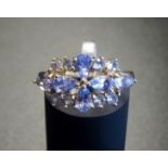 TANZANITE CLUSTER RING the pear and round cut tanzanites in pierced setting, on nine carat gold