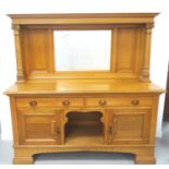 ARTS AND CRAFTS OAK MIRROR BACK SIDEBOARD with a moulded top supported by two tapering square