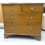 MAHOGANY DRESSING CHEST with a shaped raised back above two short and two long drawers, standing