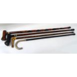 SELECTION OF FOUR WALKING STICKS one with an ebonised cane and white metal handle marked Pierre