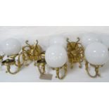 SET OF FOUR GILT BRASS WALL LIGHTS each with a pair of scroll arms and five opaque circular glass