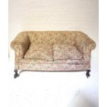 EDWARDIAN TWO SEATER SETTEE in floral coloured fabric, raised on front ball and claw feet with