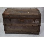 VINTAGE METAL BOUND TRAVEL TRUNK with domed top and metal carrying handles, 67.7cm wide