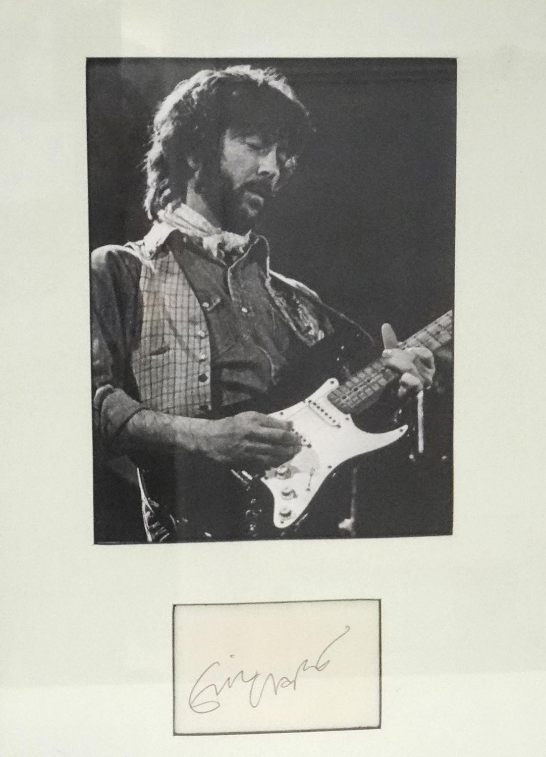 ERIC CLAPTON SIGNATURE PIECE a photographic image mounted above a signature card, framed and under