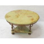 ONYX CIRCULAR TABLE with pierced gilt metal apron, the top raised by three gilt metal figures on