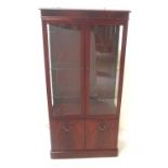 MAHOGANY DISPLAY CABINET with double glazed doors, glass shelf interior, above a double cupboard