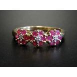RUBY AND DIAMOND TRIPLE CLUSTER RING each of the three small diamonds in six ruby surround, on