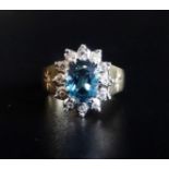 BLUE TOPAZ AND DIAMOND CLUSTER RING the central oval cut topaz approximately 1.25cts in twelve