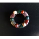 CIRCULAR SCOTTISH PEBBLE BROOCH with various coloured agate sections, in unmarked silver, 4.5cm