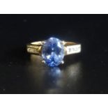 TANZANITE AND DIAMOND RING the central oval cut tanzanite approximately 1.5cts flanked by channel