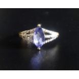 TANZANITE AND DIAMOND RING the central maquise cut tanzanite flanked by diamond set triple split