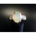 ETHIOPIAN OPAL AND DIAMOND DRESS RING the large oval brilliant cut opal with Gem Collector