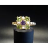 UNUSUAL 'SUFFRAGETTE' RING the central amethyst in peridot and pearl surround representing the