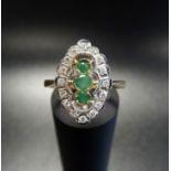 ART DECO STYLE EMERALD AND DIAMOND PLAQUE RING the central three vertically set emeralds in marquise