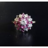 DIAMOND AND RUBY CLUSTER RING with stepped setting, on nine carat gold shank, ring size L-M