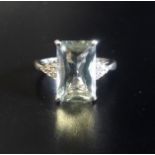 AQUAMARINE AND DIAMOND DRESS RING the central emerald cut aquamarine approximately 3cts flanked by