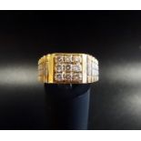 GENTLEMAN'S DIAMOND SET RING in unmarked gold with two tone stepped shoulders, the diamonds in