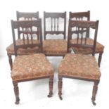 SET OF FIVE EDWARDIAN OAK DINING CHAIRS each with a carved top rail above three turned columns, with