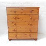 PINE CHEST with a moulded top above five long drawer with turned handles, standing on flattened