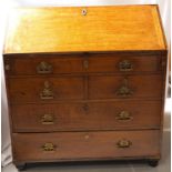 LATE 18TH CENTURY OAK BUREAU with a fall flap revealing a fitted interior of drawers and pigeon