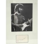 ERIC CLAPTON SIGNATURE PIECE a photographic image mounted above a signature card, framed and under