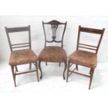 PAIR OF EDWARDIAN OAK SIDE CHAIRS each with a carved top rail above a floral stuffover seat,