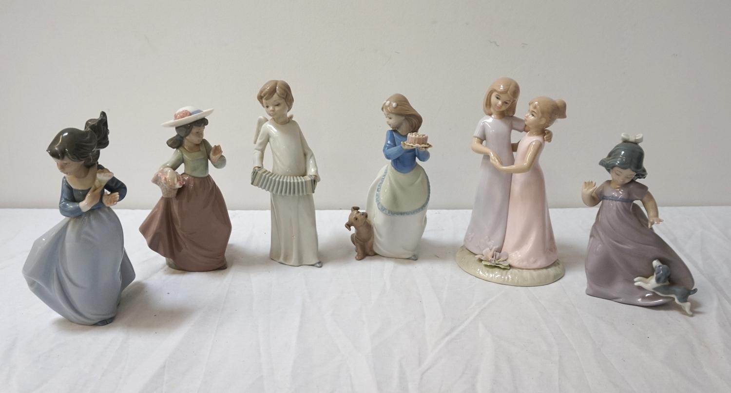 FIVE NAO PORCELAIN FIGURINES including a young girl holding a cake with a dog beside her, 18.5cm